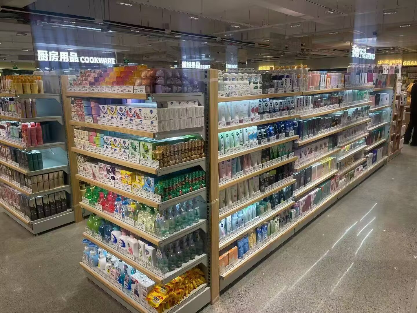 Retail Supermarket Shelving - Grocery Store Display Racks Supermarket display shelves with adjustable tiers, used for retail food and beverage products in a grocery store aisle